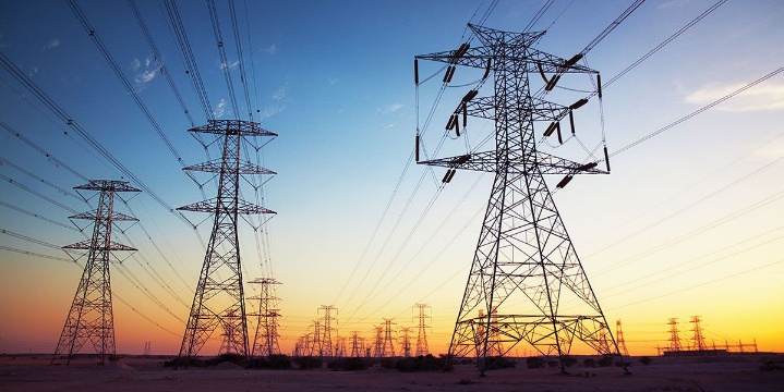 High-voltage transmission towers at sunset representing critical infrastructure